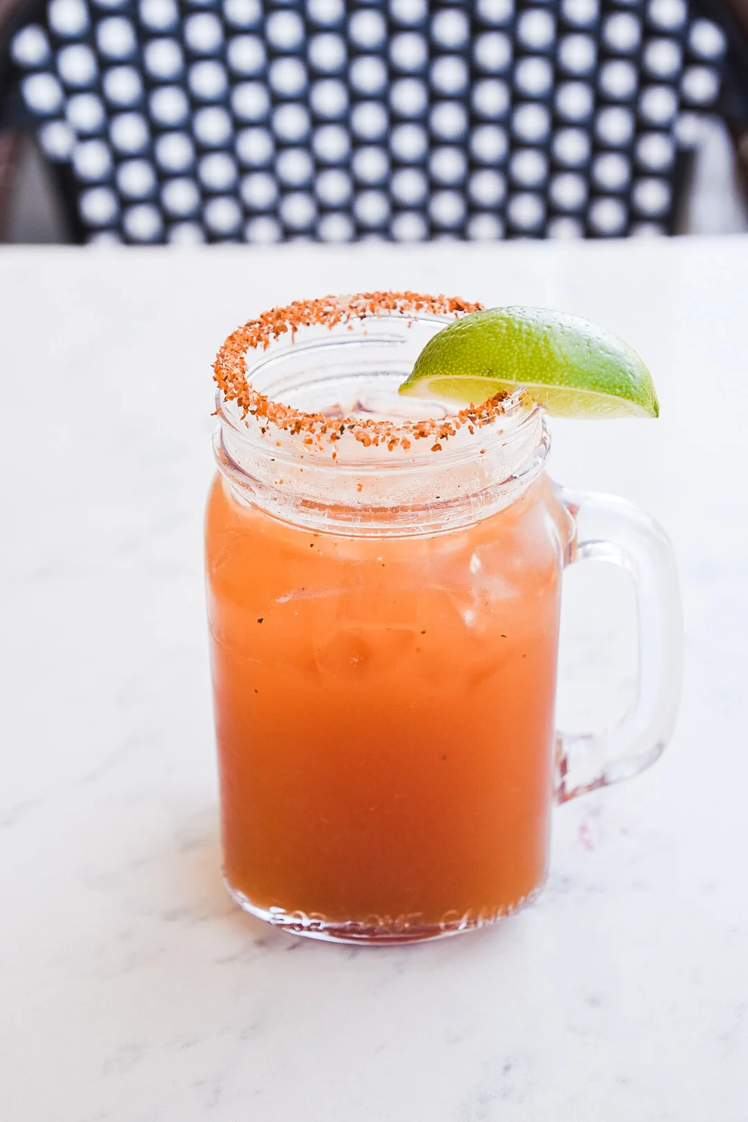 The Judge cocktail with tomato juice mix, Corona, Tajín, and lime