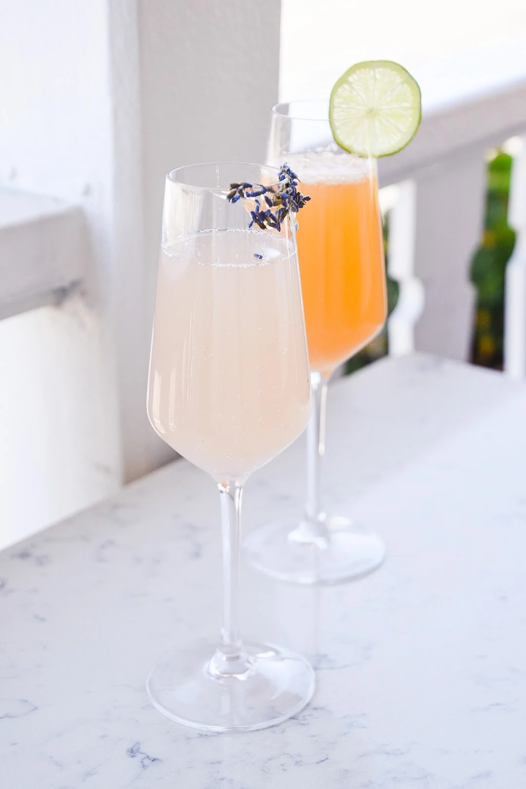 The Lady cocktail with lavender garnish beside an Ortega cocktail