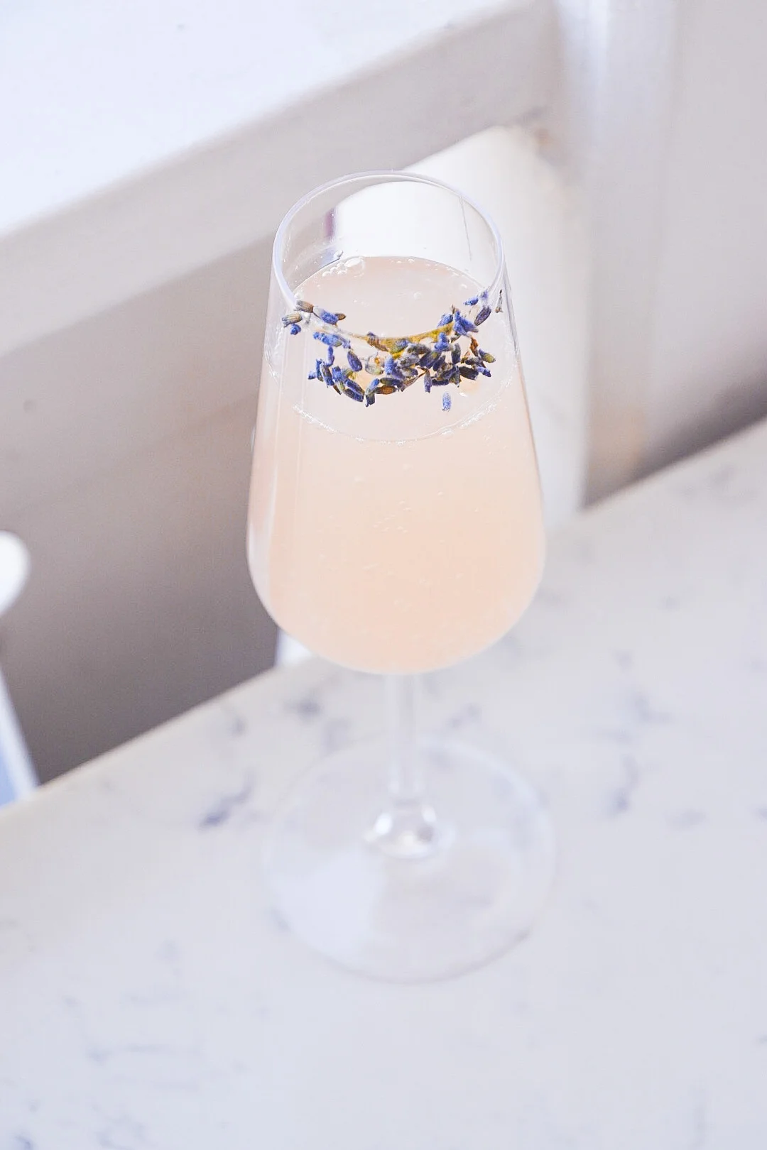 The Lady cocktail with lavender lemonade, champagne, and lavender garnish