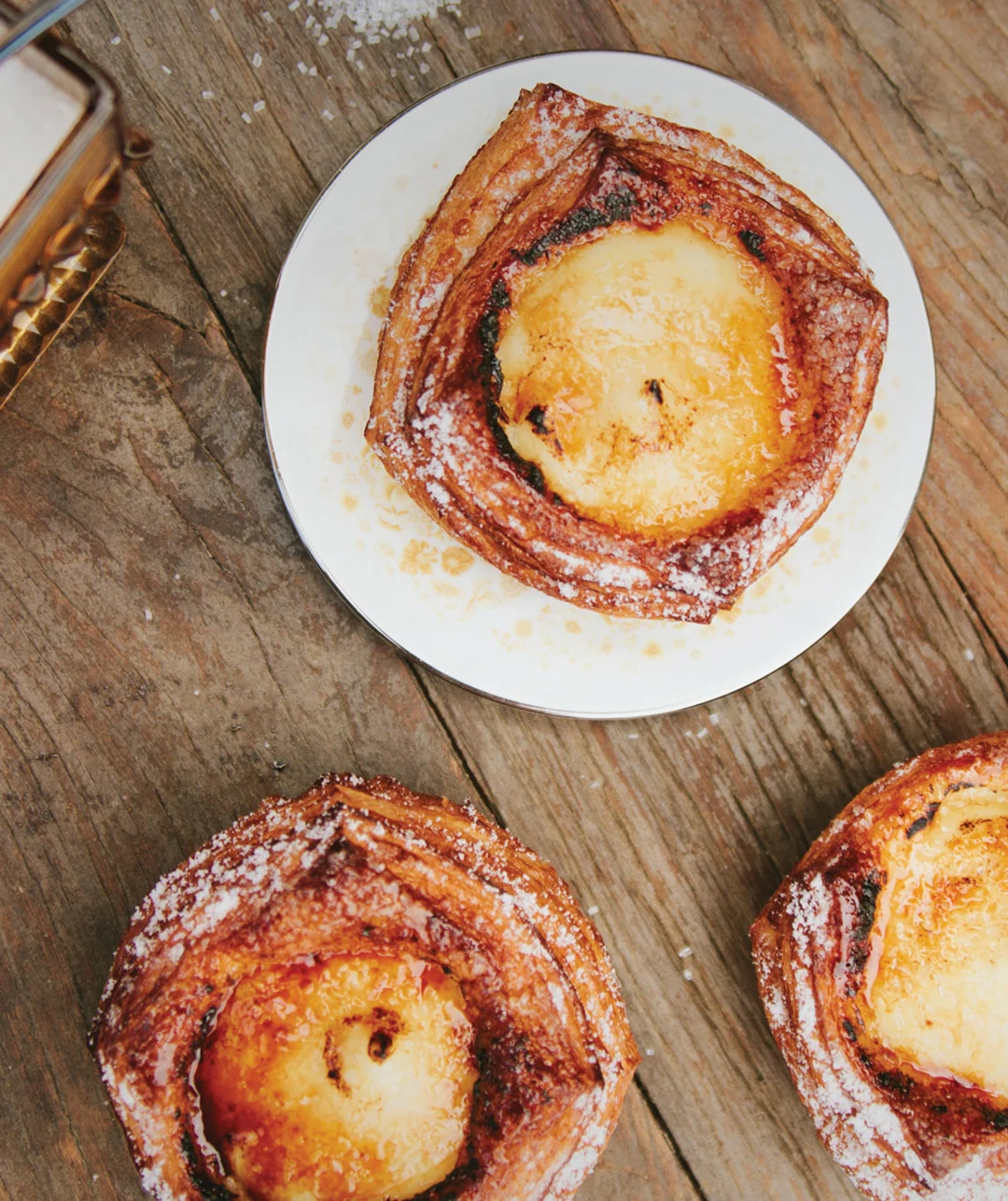 Three custard-filled kouign-amann pastries
