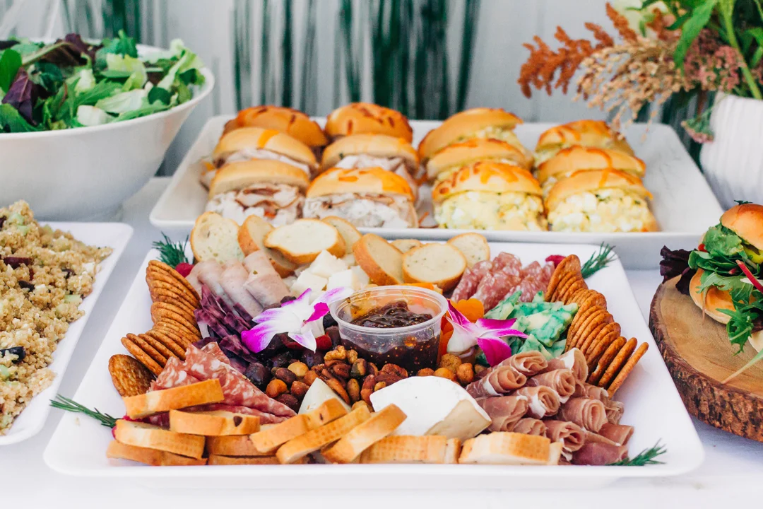 Charcuterie board and sliders on the baby shower grazing table