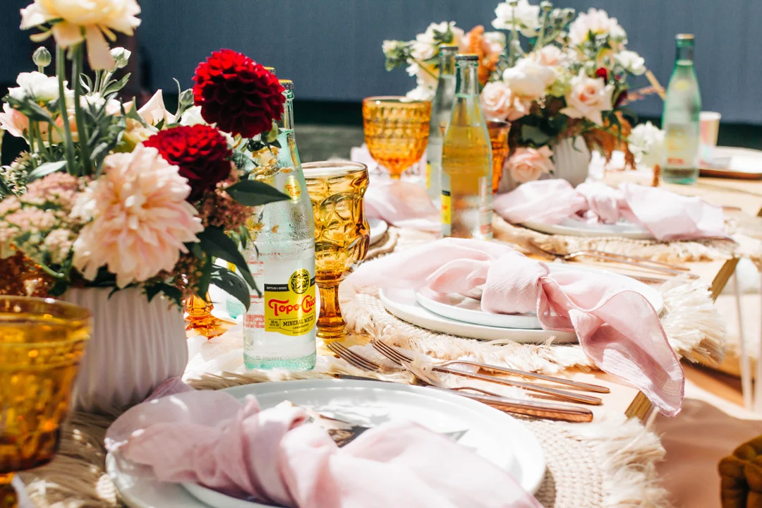 Blush and amber baby shower place setting with a floral centerpiece