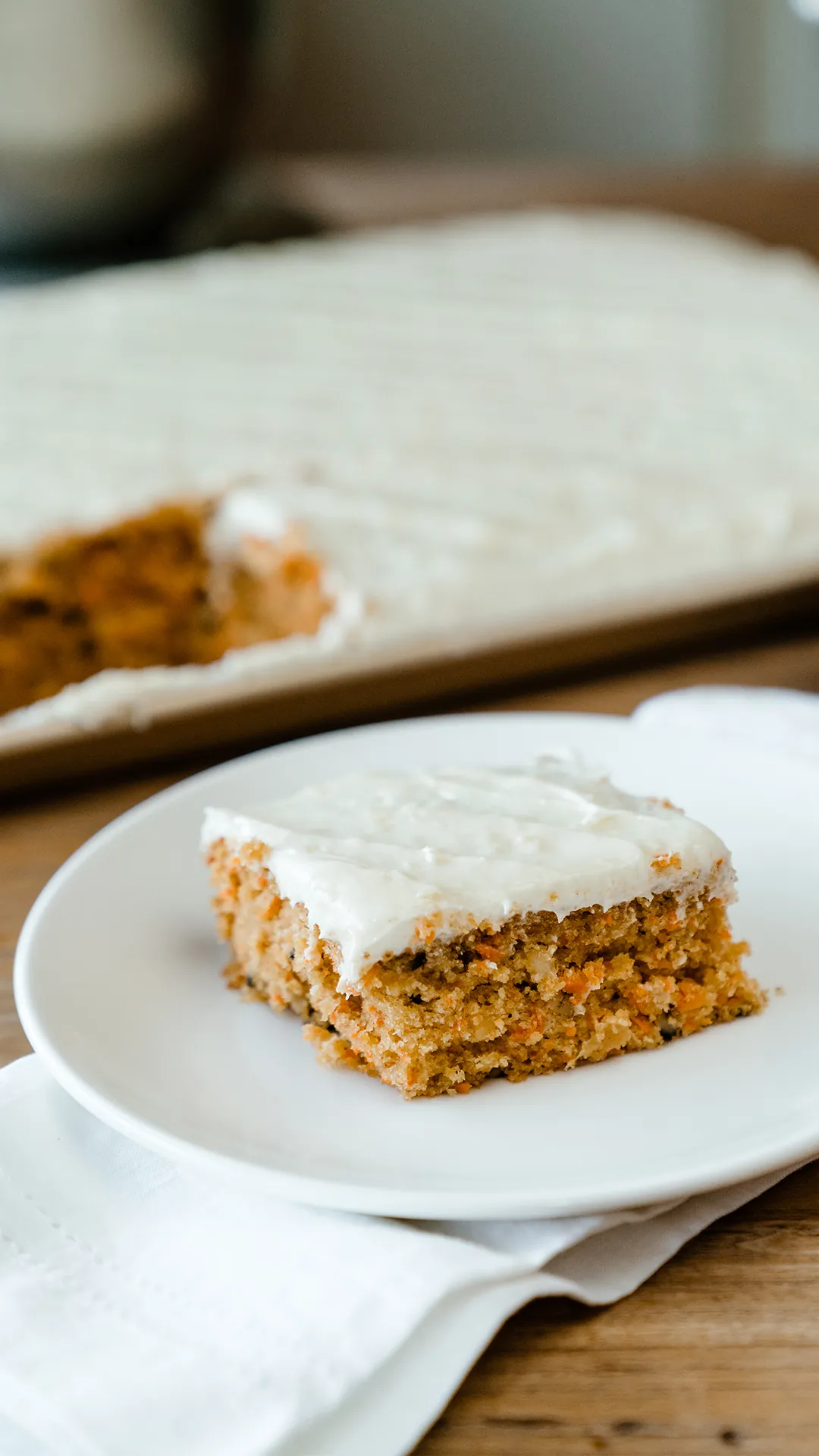 Slice of Ellie’s carrot cake with cream cheese frosting