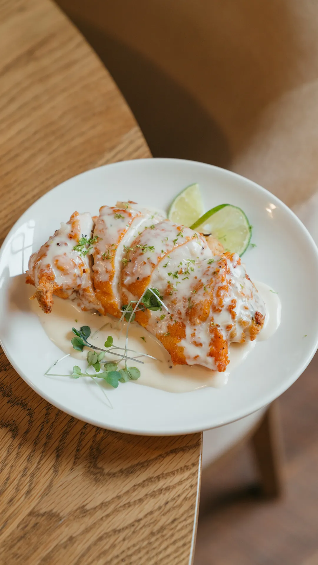 Zucchini lime chicken with cream sauce and lime wedges