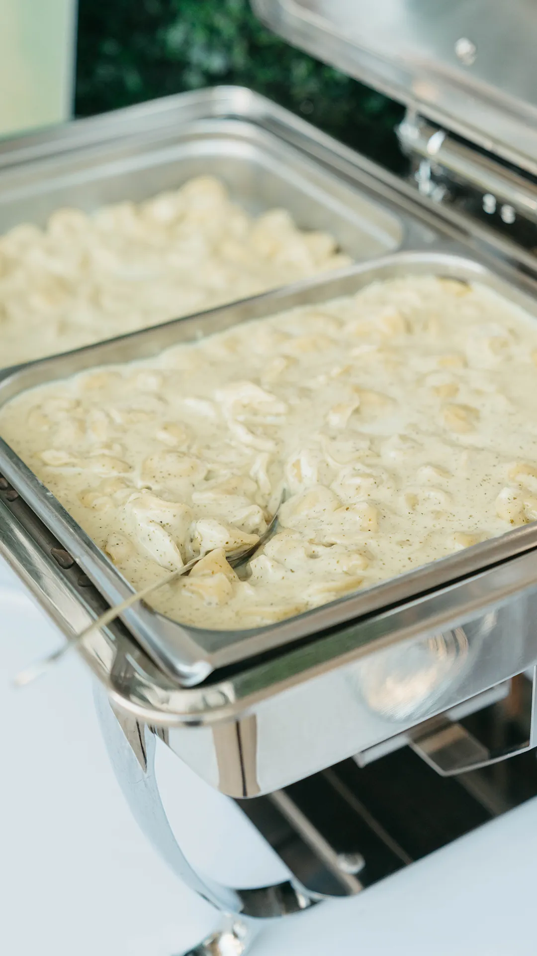 Creamy tortellini in a buffet chafing dish