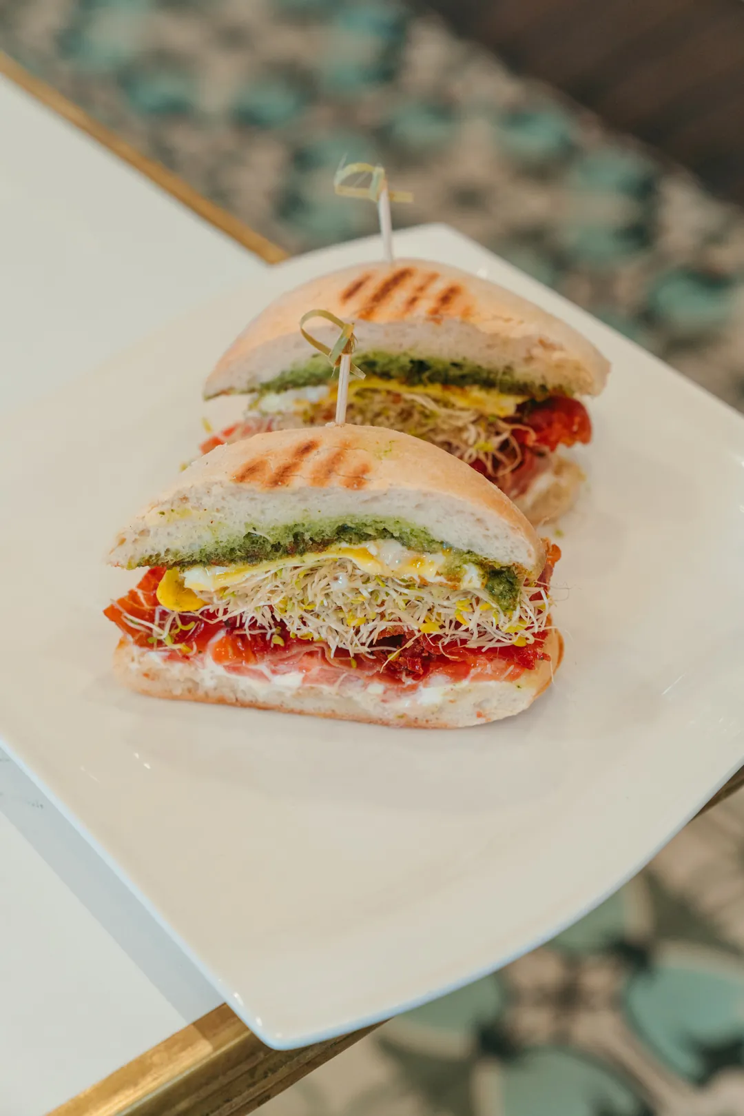 Prosciutto AM sandwich with egg, tomato, sprouts, and goat cheese