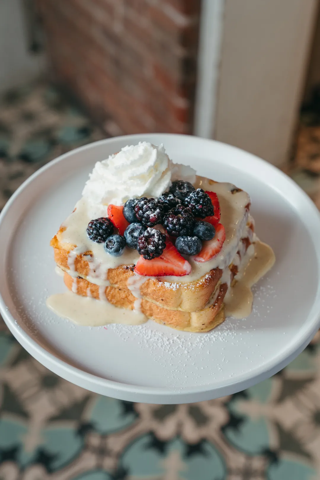 Berries and cream French toast with strawberries, blueberries, and blackberries