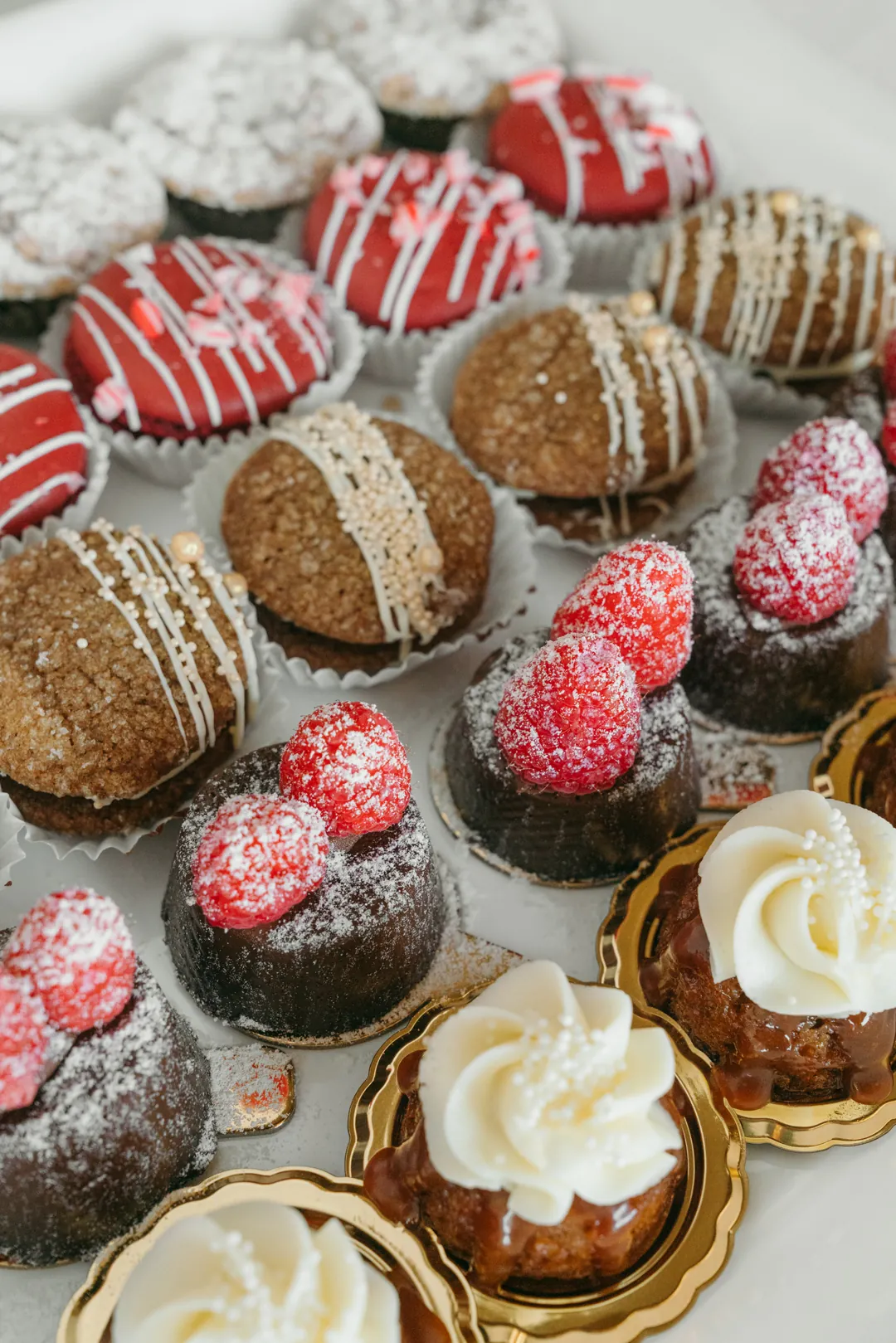 Assorted individual chocolate cakes, bundt cakes, and frosted pastries
