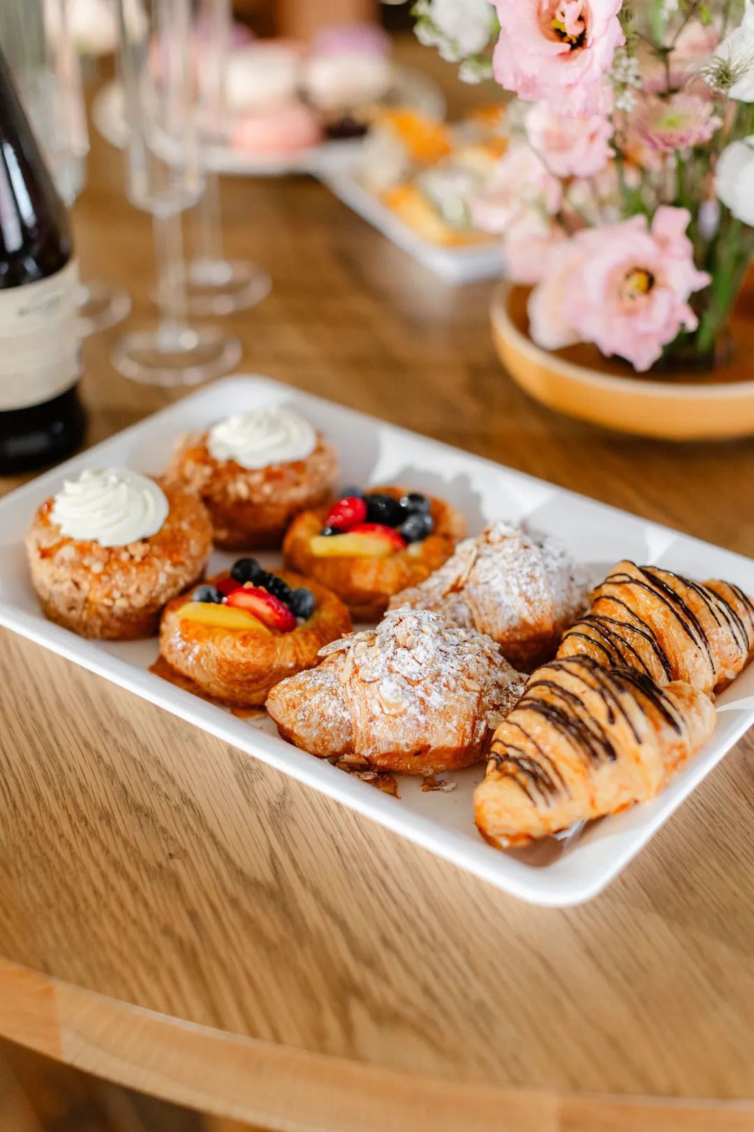 Platter of croissants, fruit danishes, and other breakfast pastries