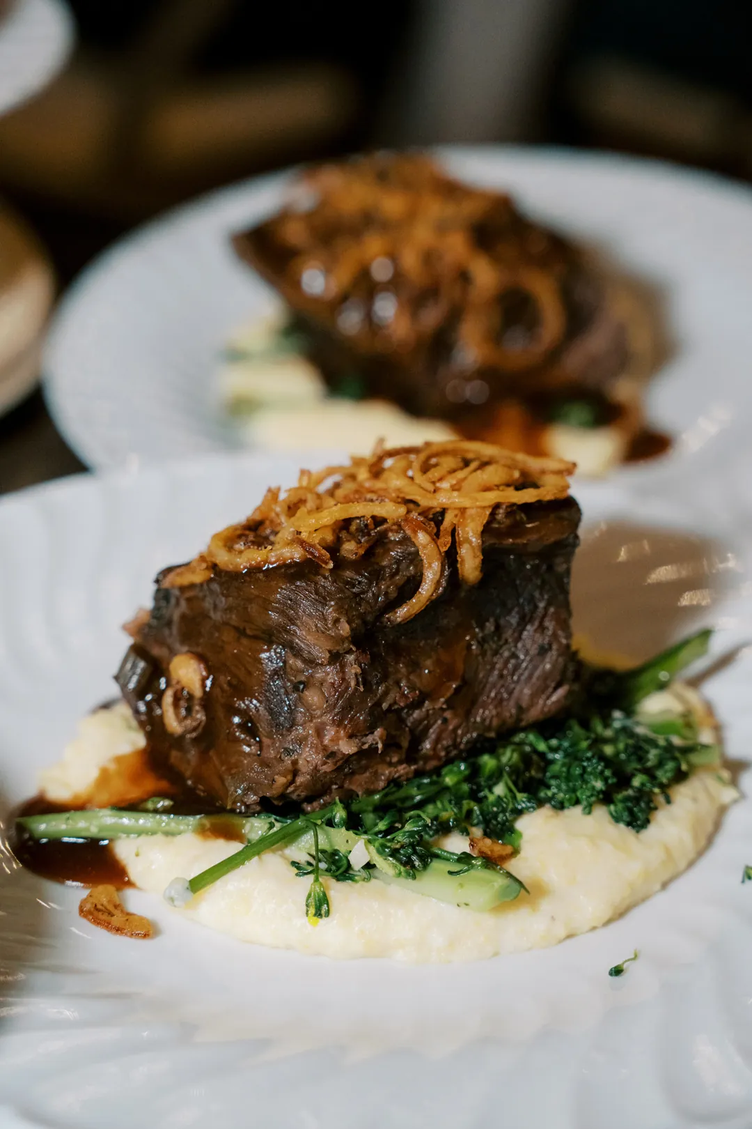 Braised beef short rib over mashed potatoes and sautéed greens