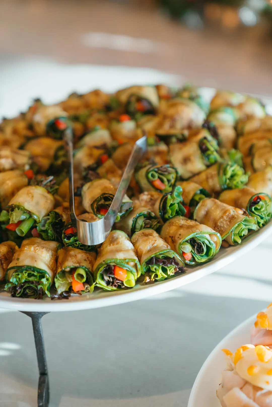Grilled zucchini rolls filled with lettuce and sliced vegetables
