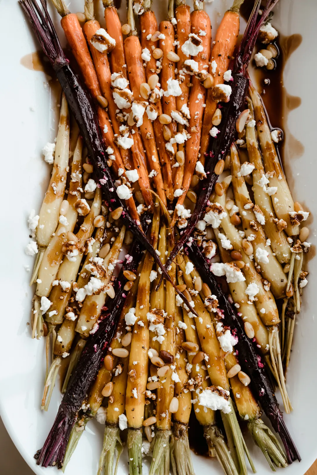 Roasted multicolored carrots topped with crumbled cheese