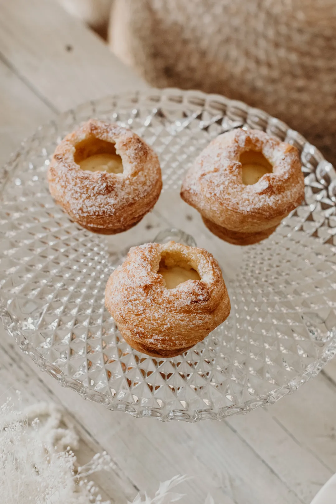 Three sugar-coated bite-size pastries on a glass plate
