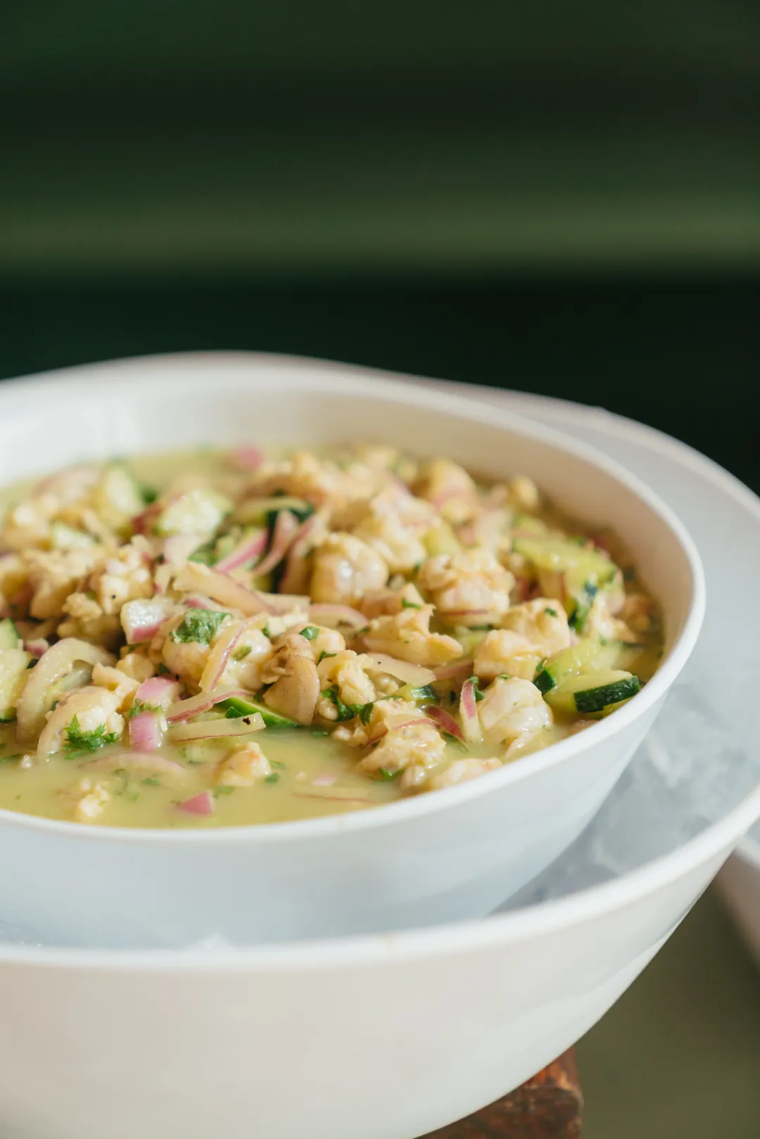 Chopped seafood with cucumber and red onion in a citrus marinade
