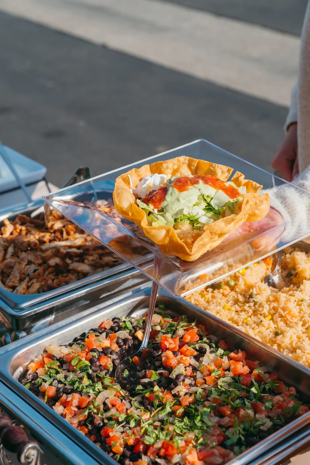 Buffet pans filled with rice and sautéed vegetables