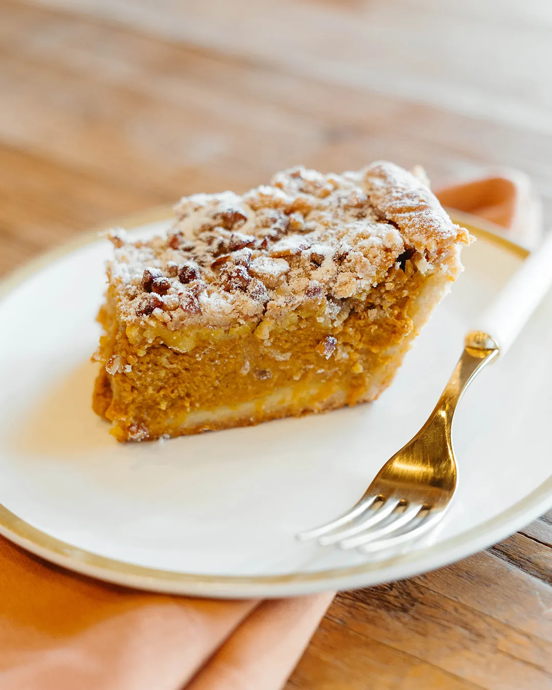 Slice of pumpkin crumb bar on a white plate