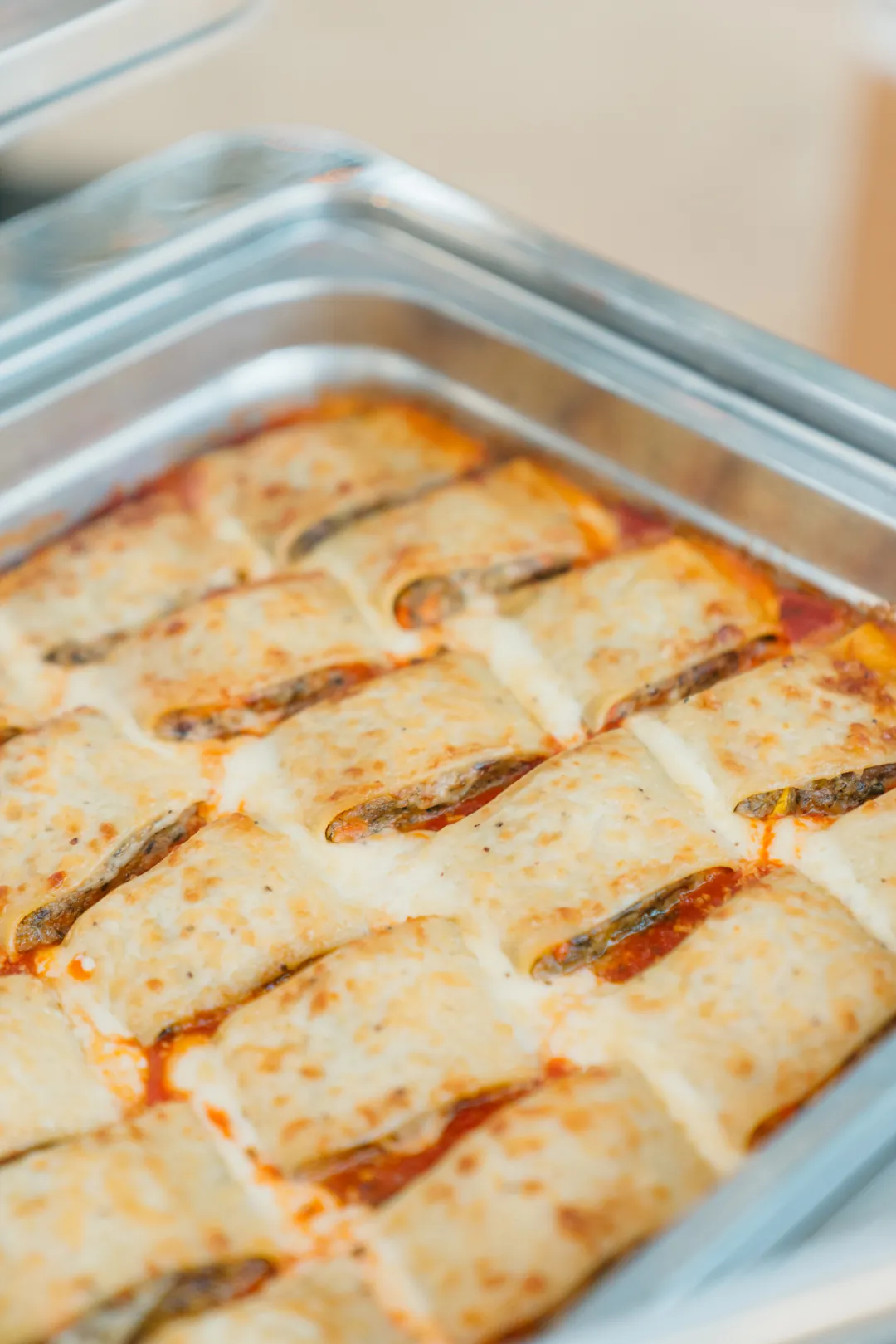 Cheese-topped eggplant rollatini in tomato sauce