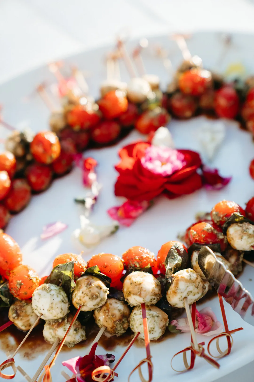 Caprese skewers with tomatoes, mozzarella, basil, and balsamic drizzle
