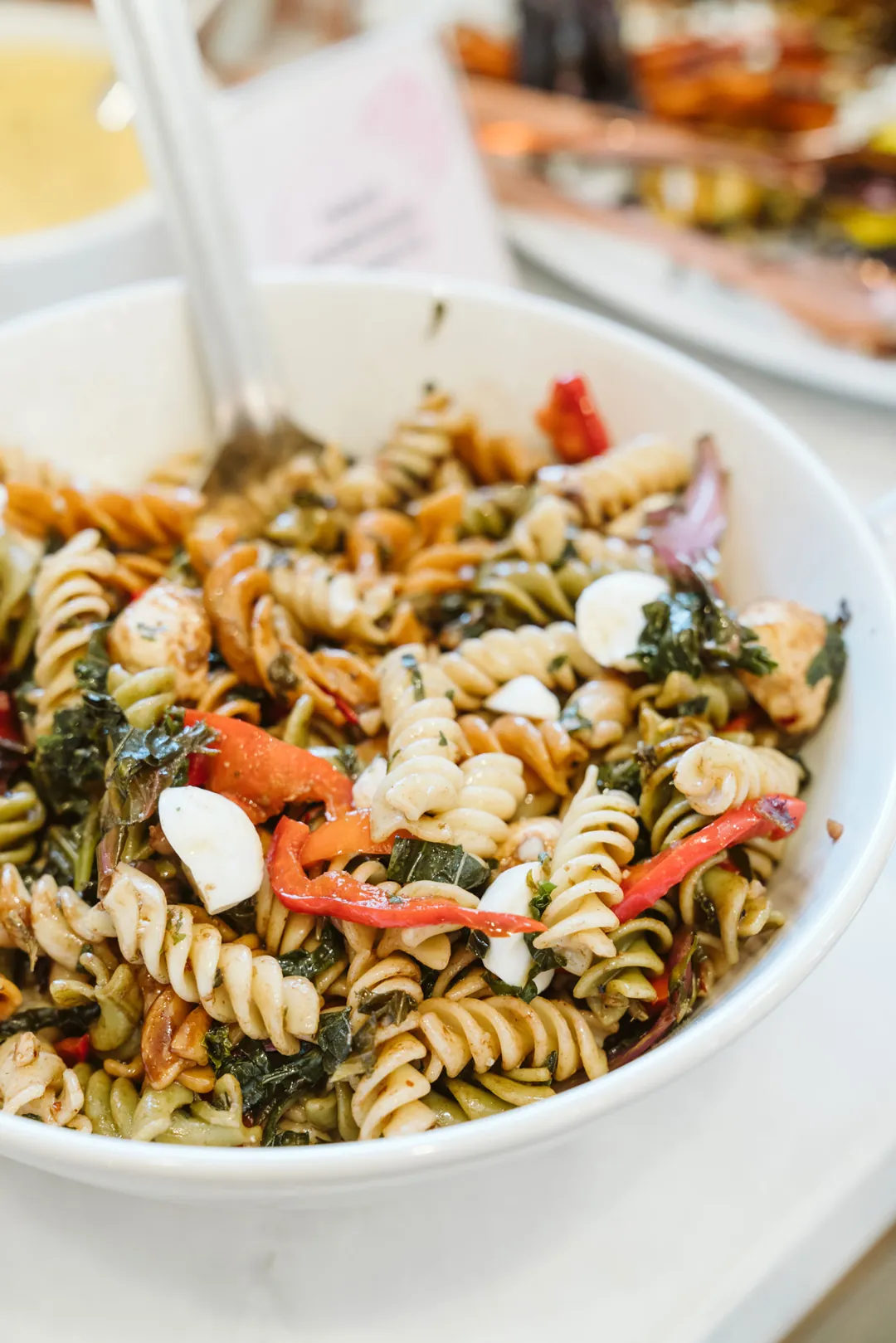 Pesto rotini pasta salad with tomatoes and vegetables