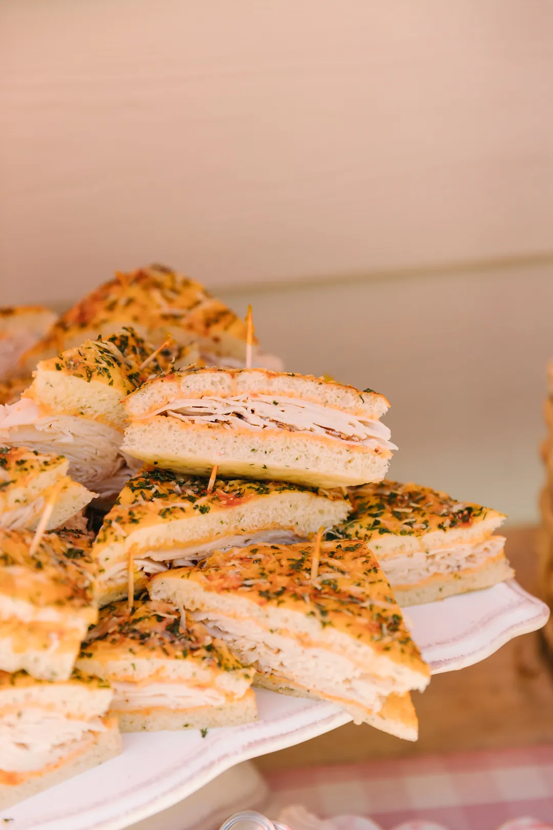 Turkey focaccia sandwiches stacked on a serving platter