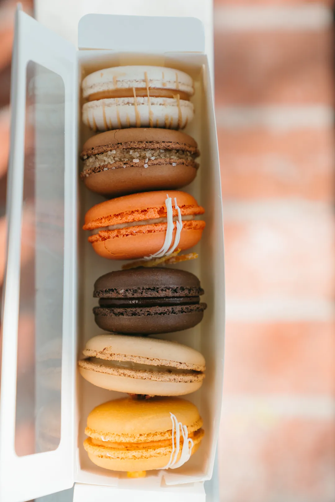 Fall macaron collection arranged in a narrow gift box
