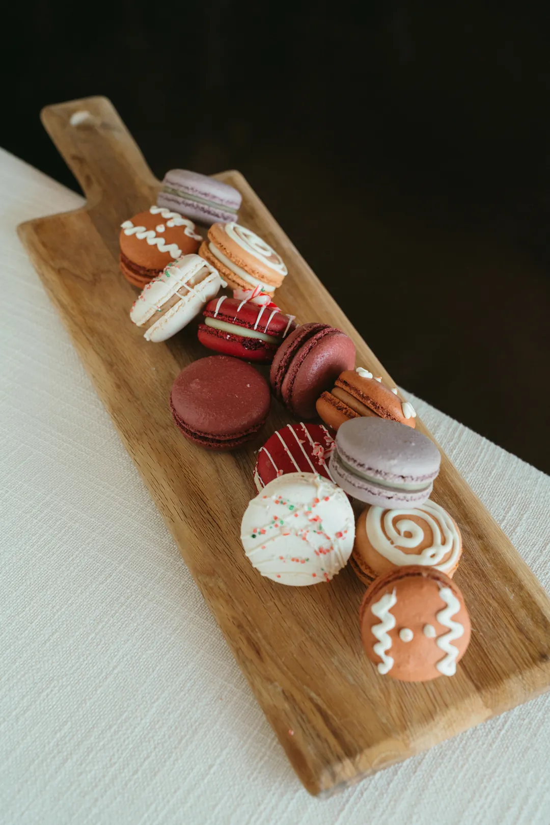 Winter macaron collection arranged on a wooden serving board