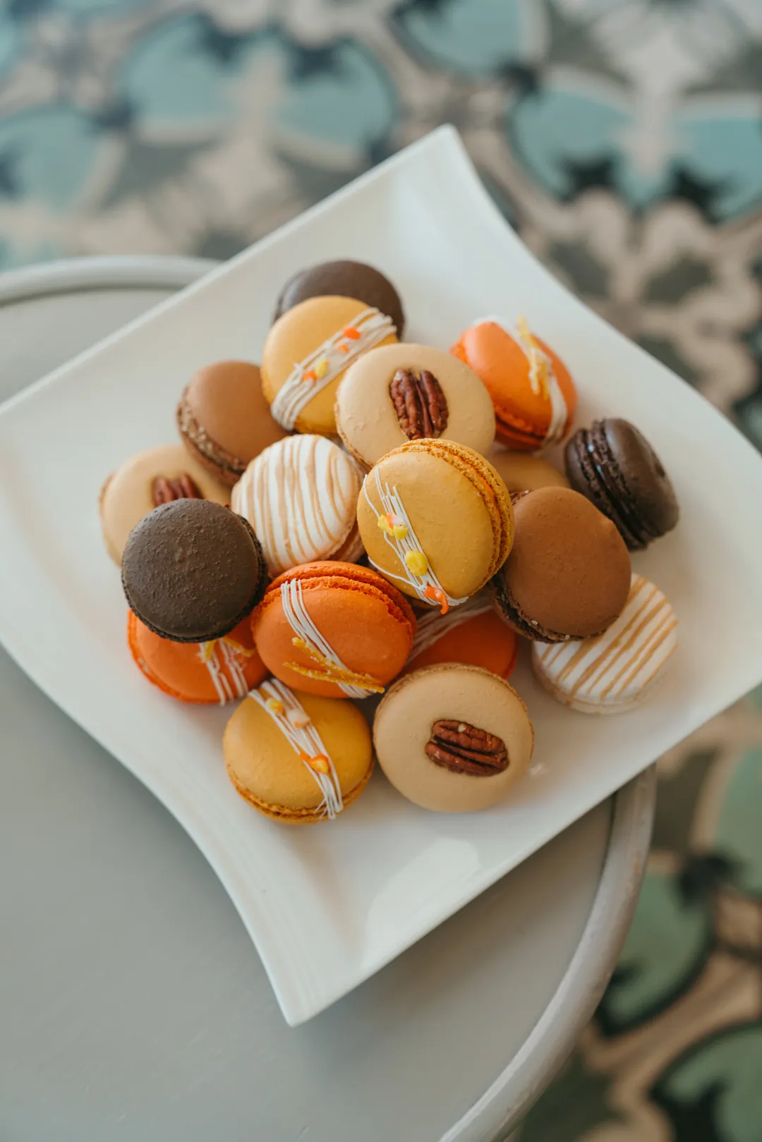 Fall macarons in caramel, orange, chocolate, and cream colors