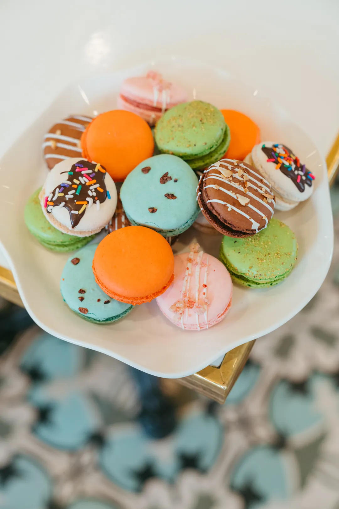 Overhead view of summer macarons on a white plate