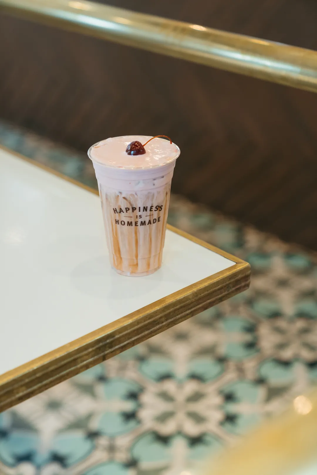 Iced cherry pie latte topped with cherry cold foam
