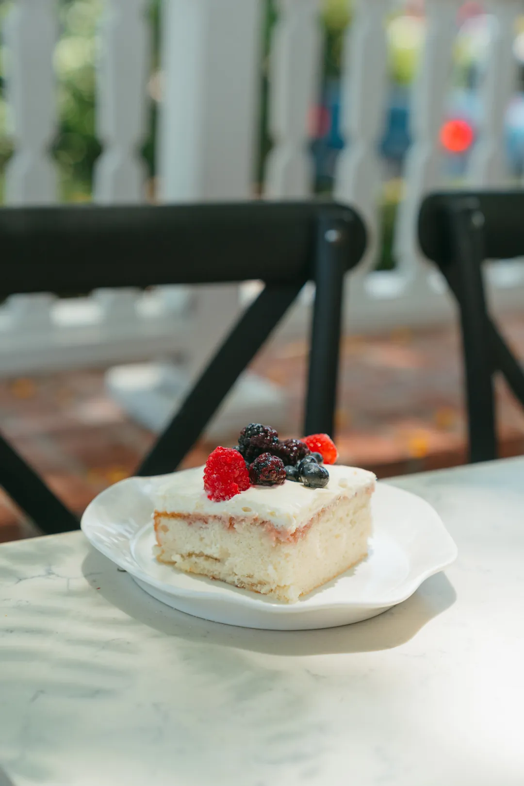Berries and cream cake topped with fresh berries