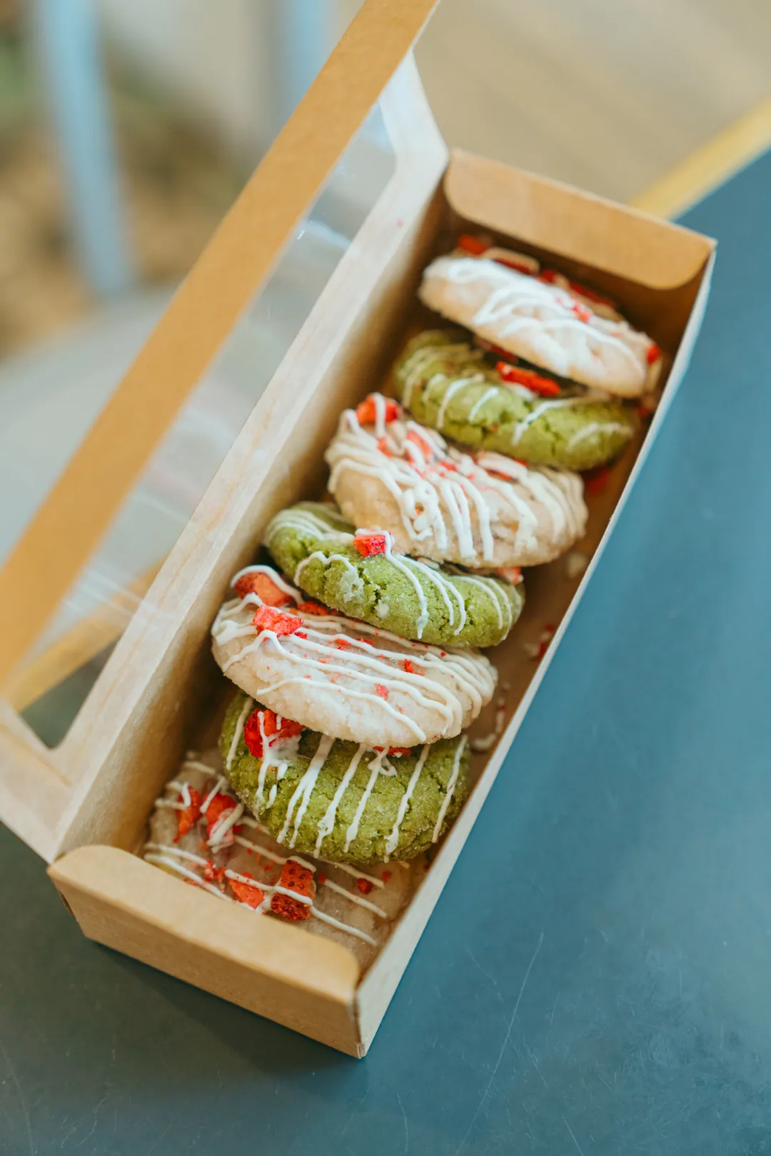 Strawberries and cream and strawberry matcha cookies in a box
