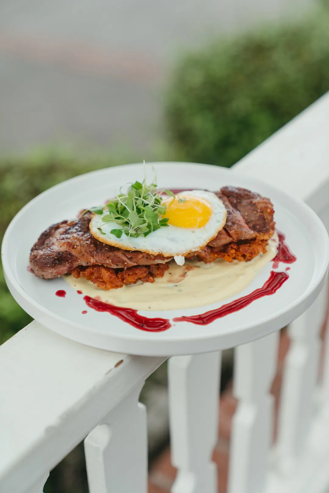 Steak and eggs with potatoes and a sunny-side egg