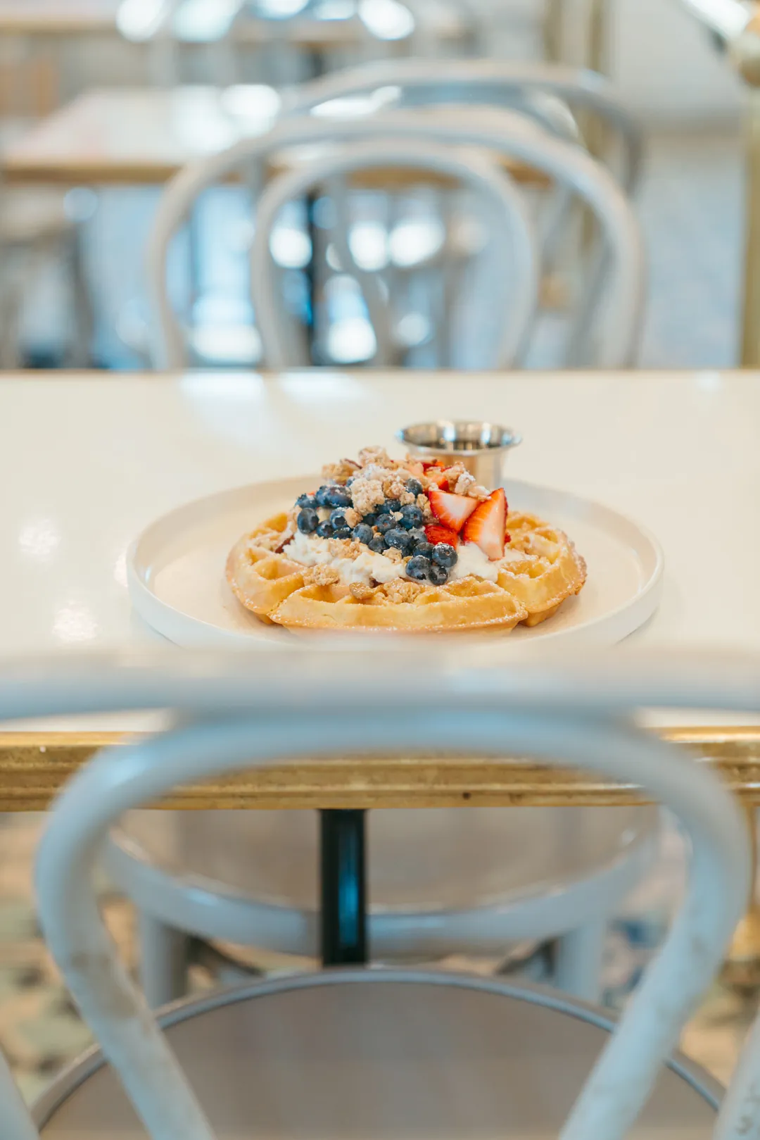 Honey lemon ricotta waffle topped with blueberries and strawberries
