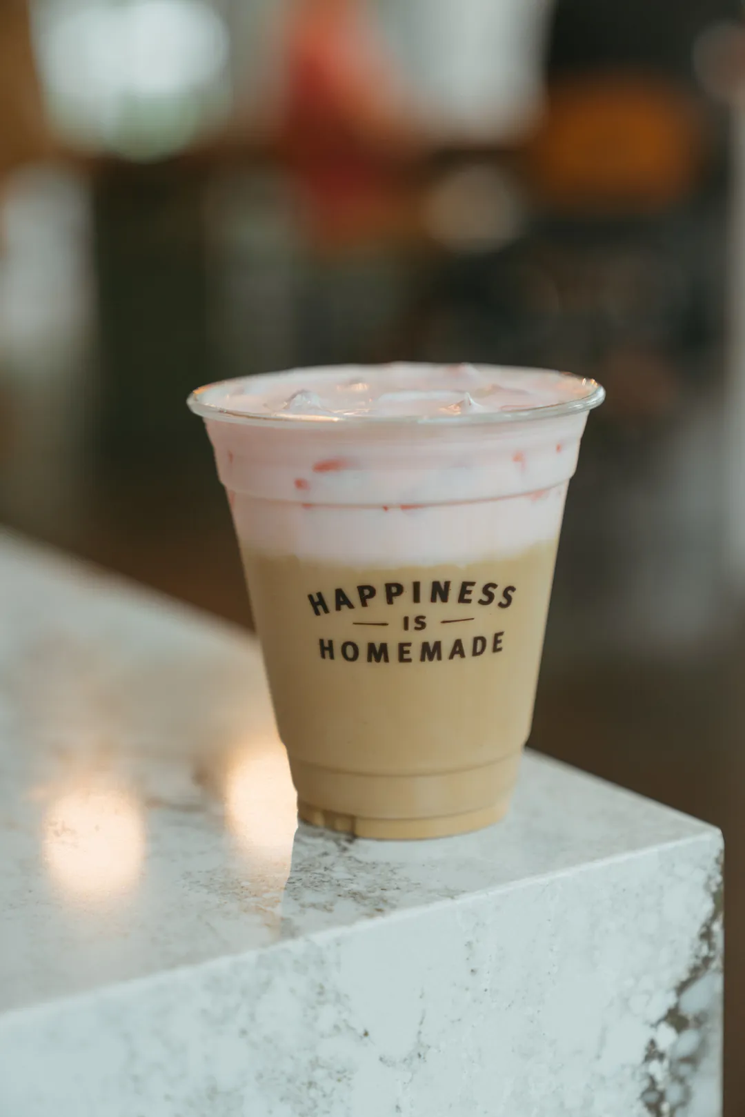 Iced coffee topped with cherry cold foam