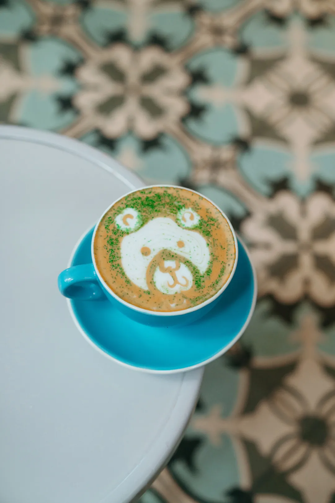 Shamrock latte with a clover design and green sprinkles