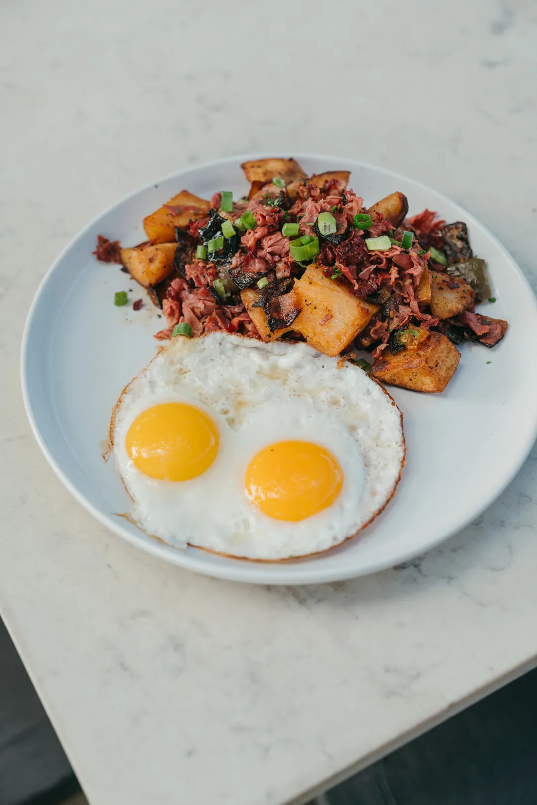 Corned beef hash with two sunny-side eggs