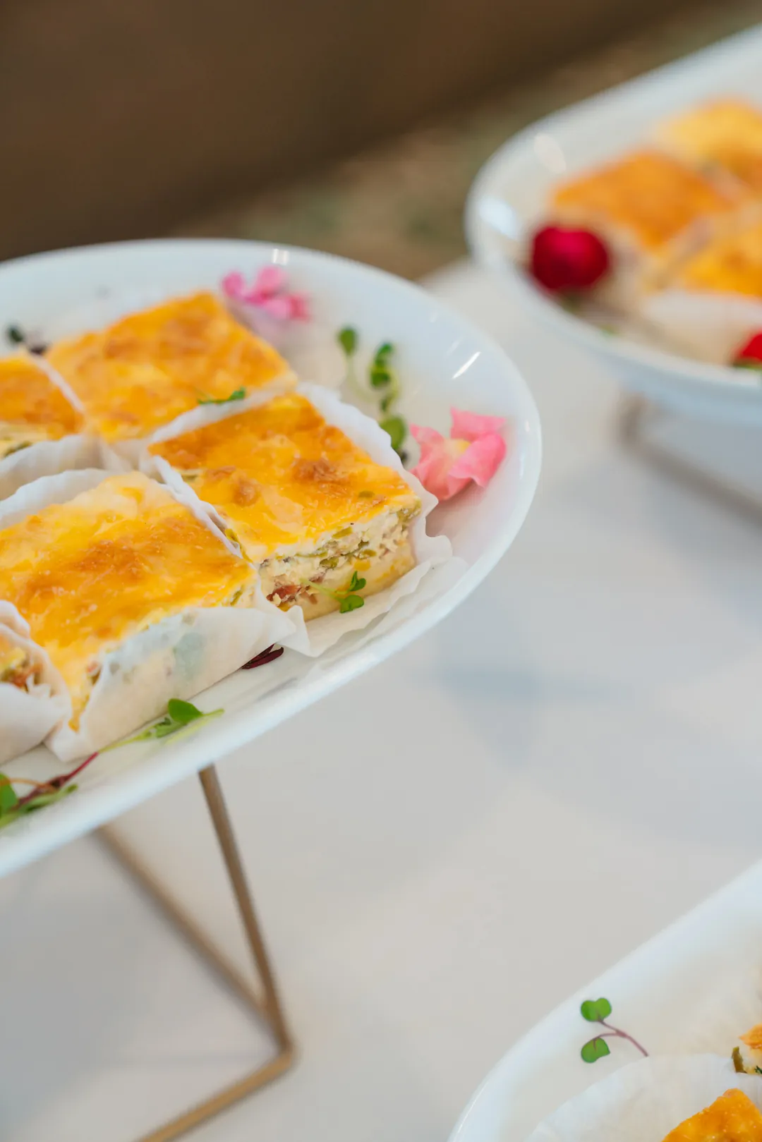 Baked quiche squares on a white platter