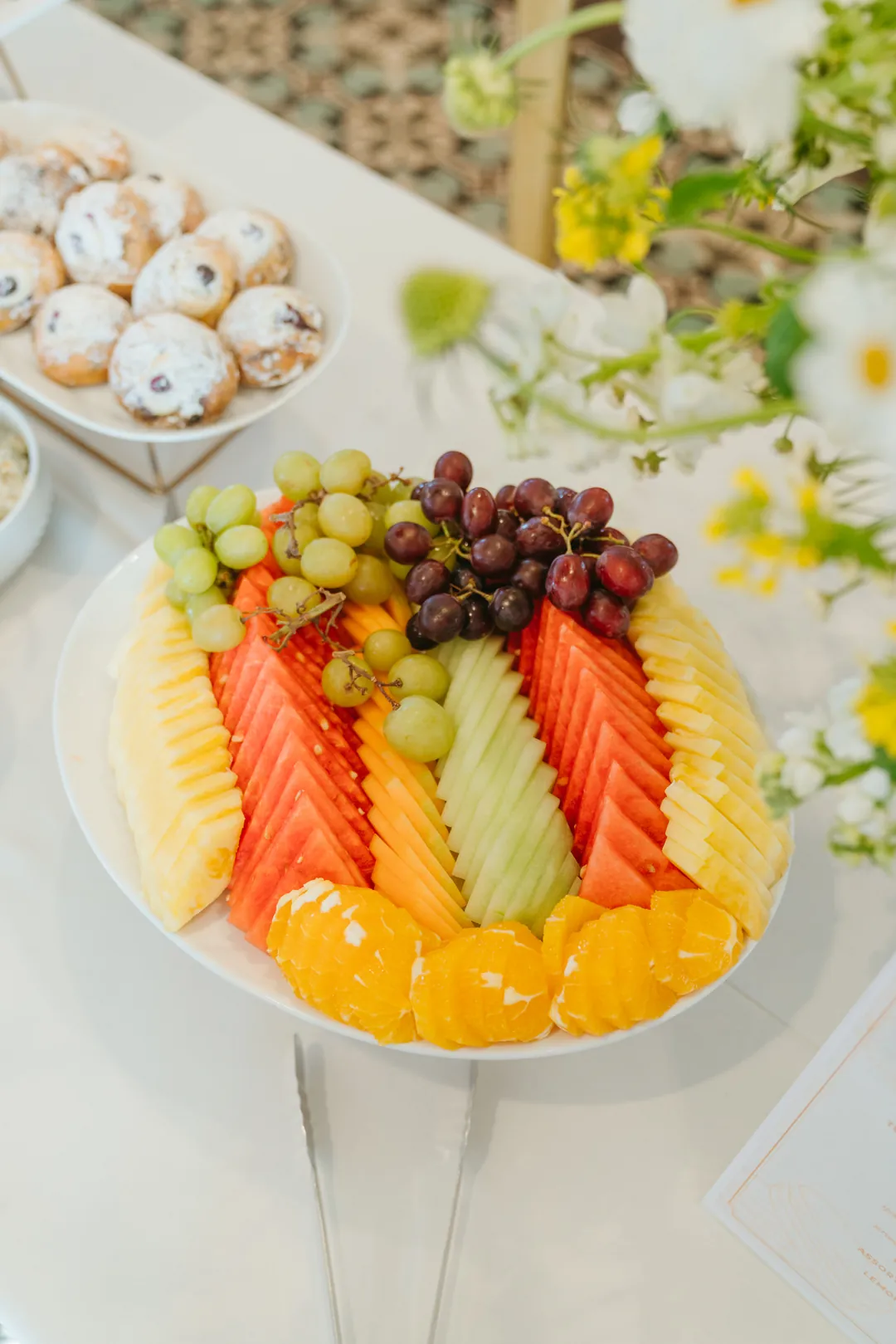 Platter of pineapple, melon, oranges, grapes and berries