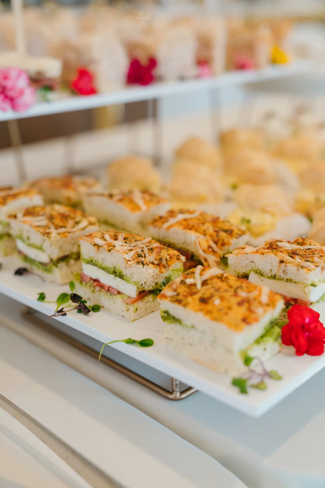 Focaccia sandwiches layered with tomato, mozzarella and pesto