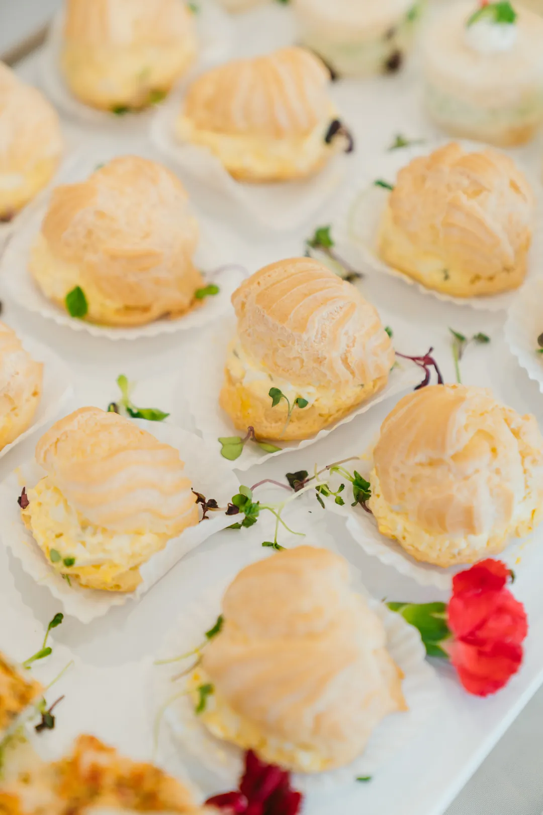 Filled savory pastry puffs on a white plate