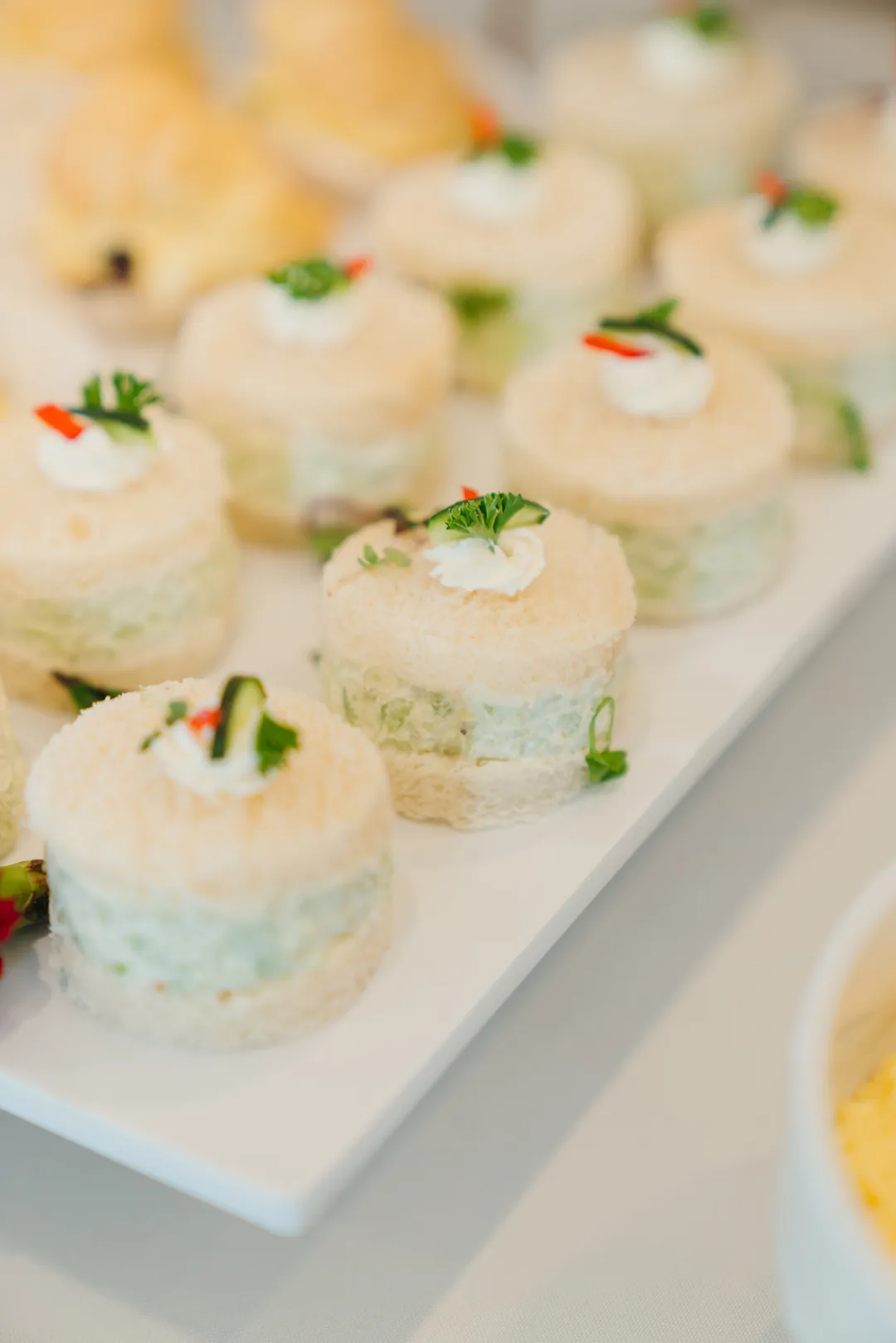 Round cucumber tea sandwiches on a platter