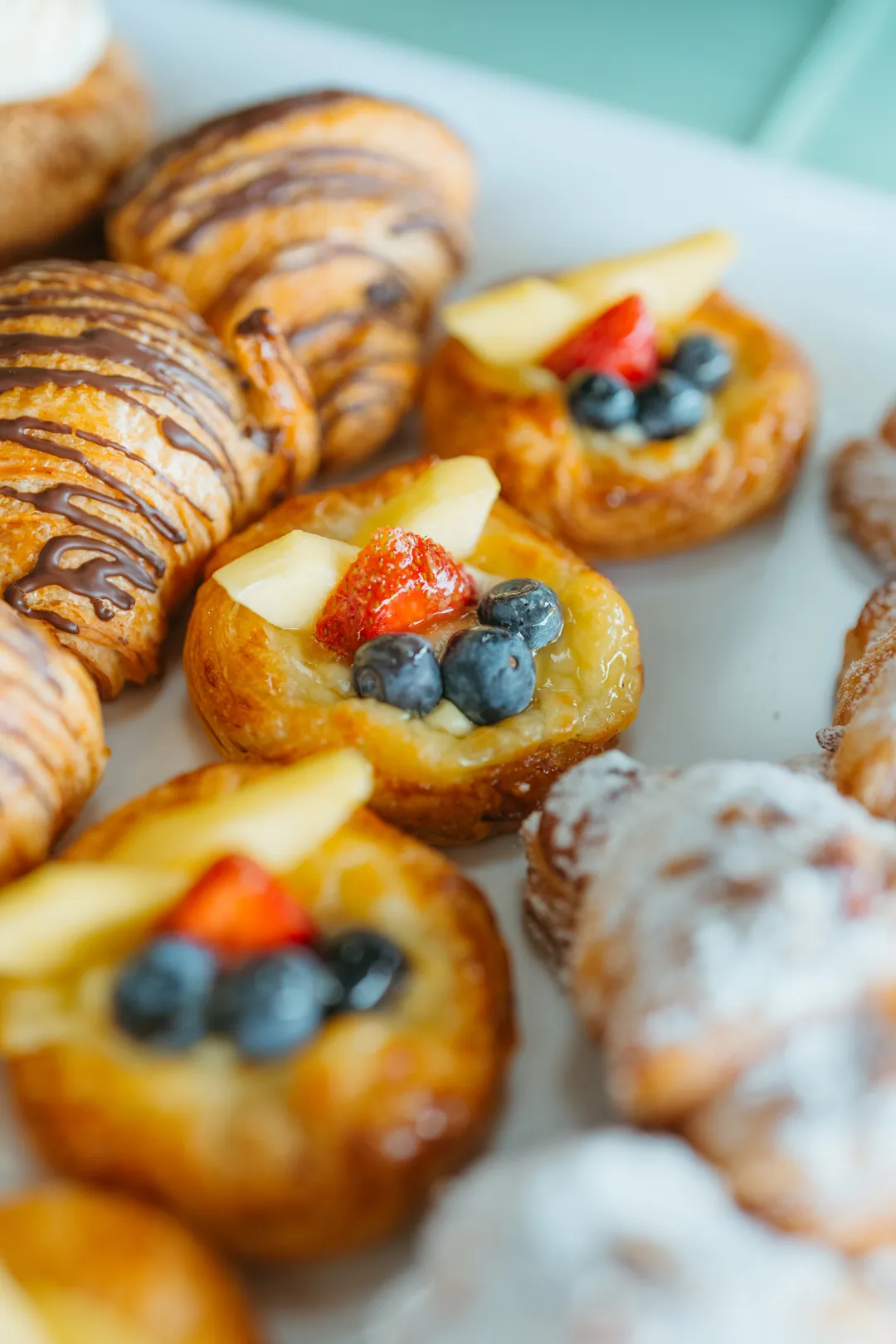 Fruit Danish topped with blueberries, strawberry and mango