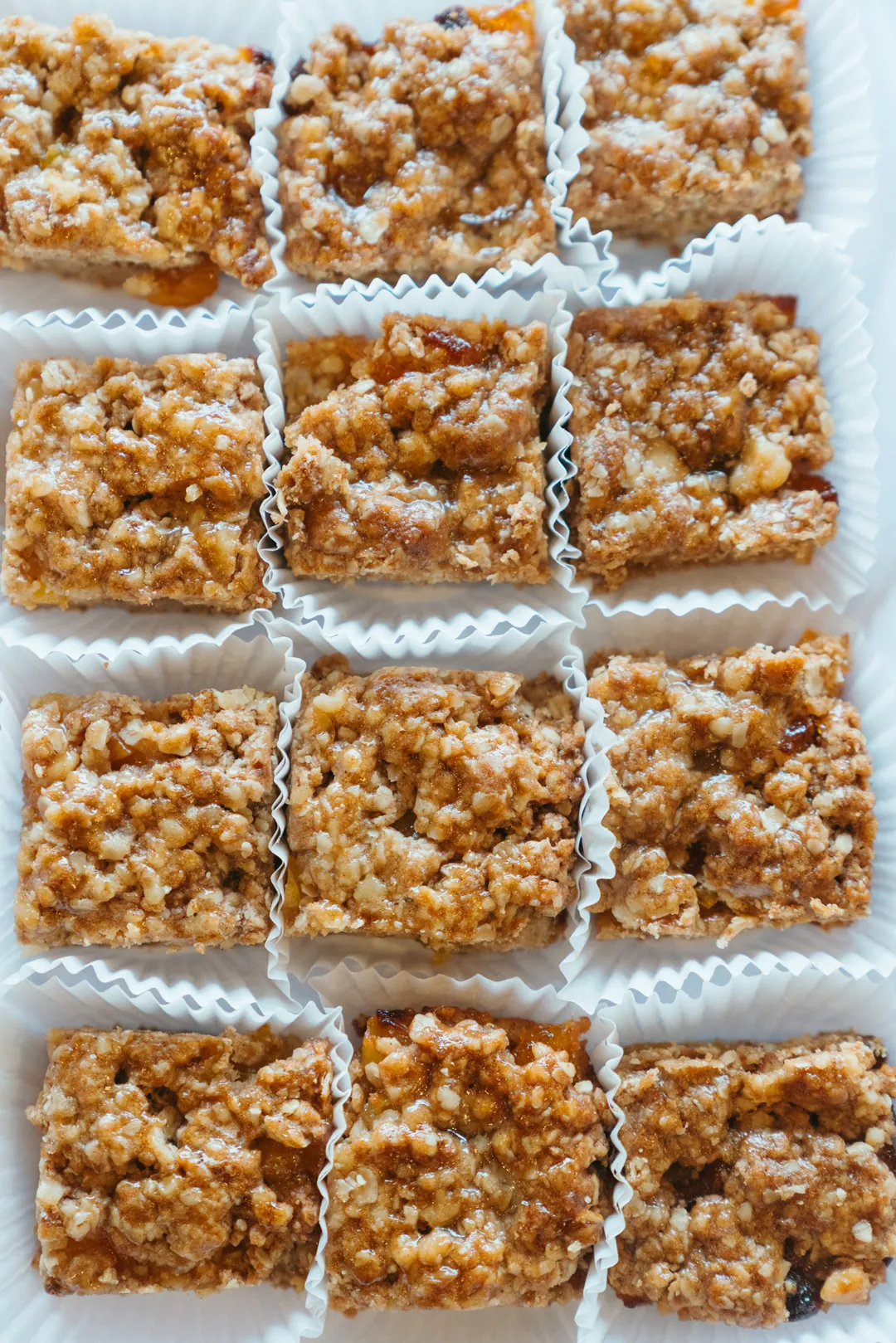 Apricot oatmeal bars in white paper cups
