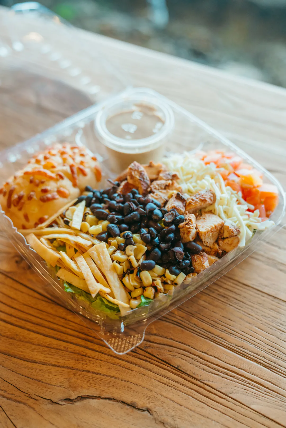 Santa Fe salad with grilled chicken, beans, corn, tortilla strips and cheese