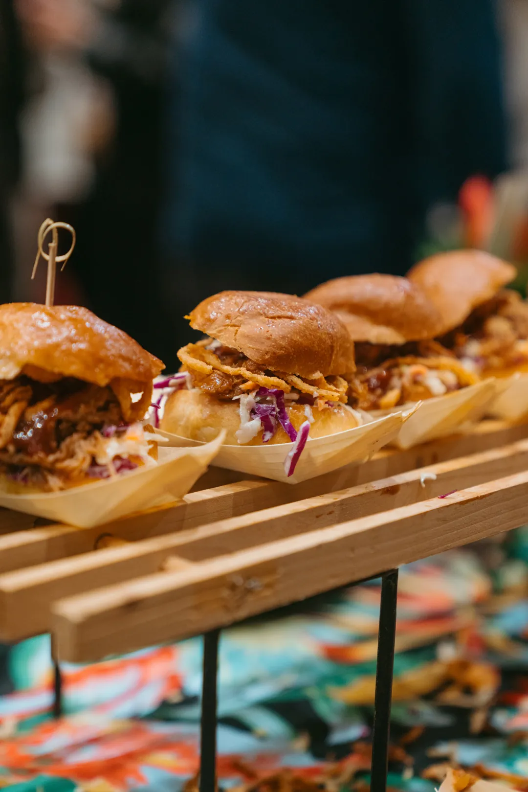 Row of Kalua pulled pork sliders at the event booth