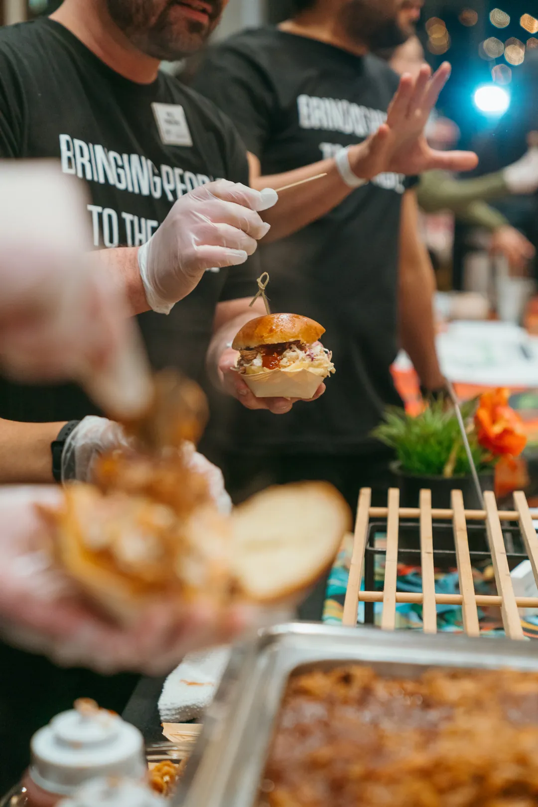 Ellie’s Table staff serving Kalua pulled pork sliders