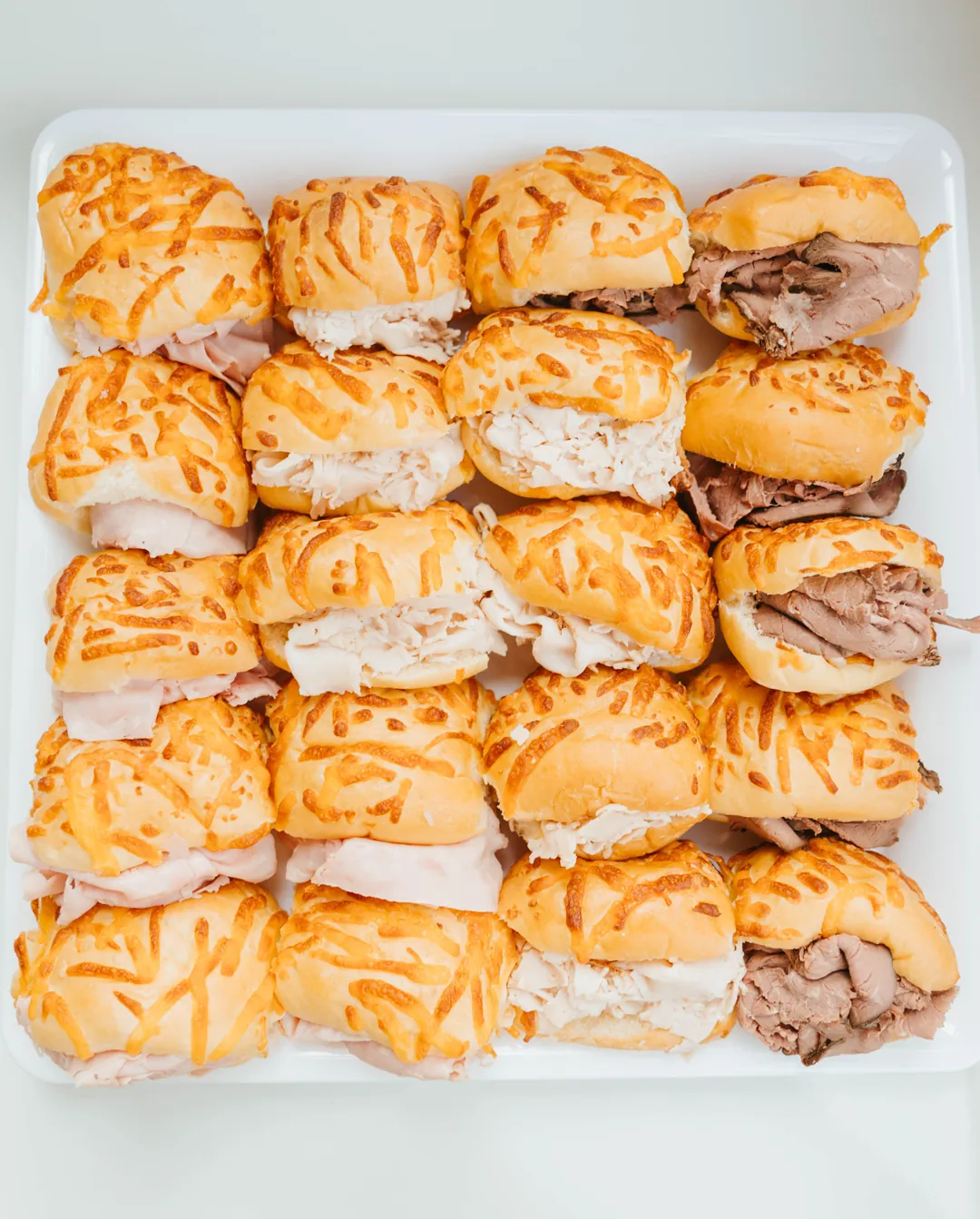 Tray of bite-size cheese roll sandwiches