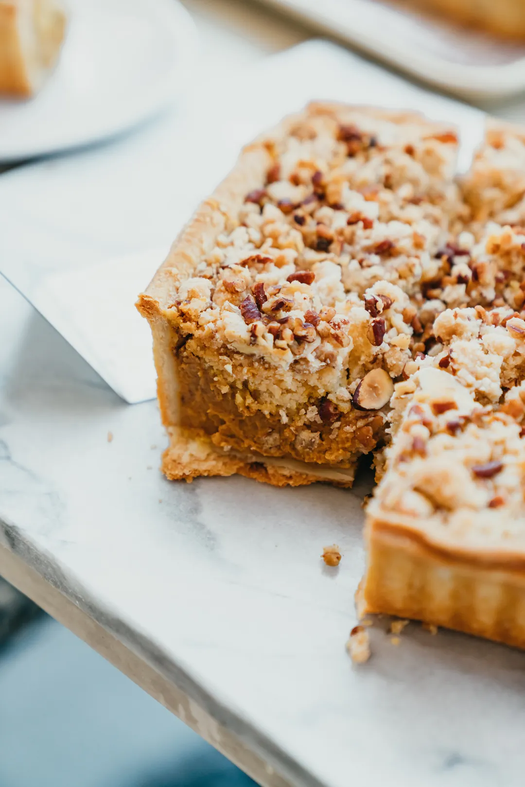 Slices of holiday pie cake topped with almonds and streusel