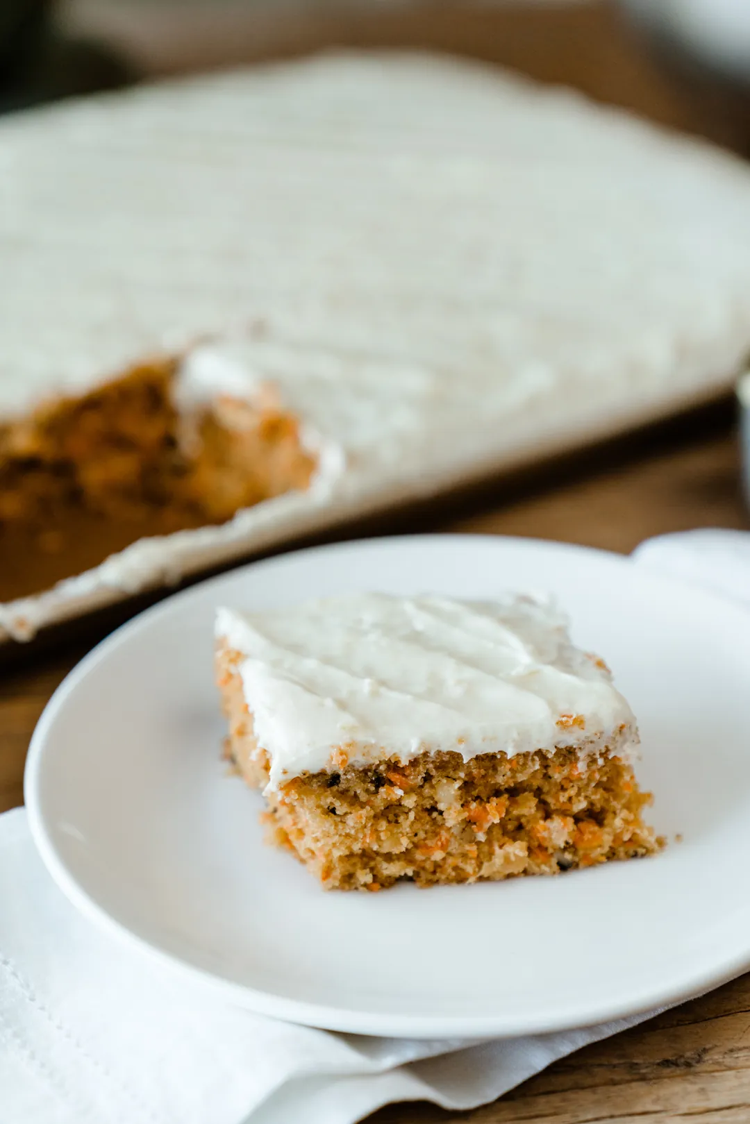 Slice of Ellie’s carrot cake with cream cheese frosting
