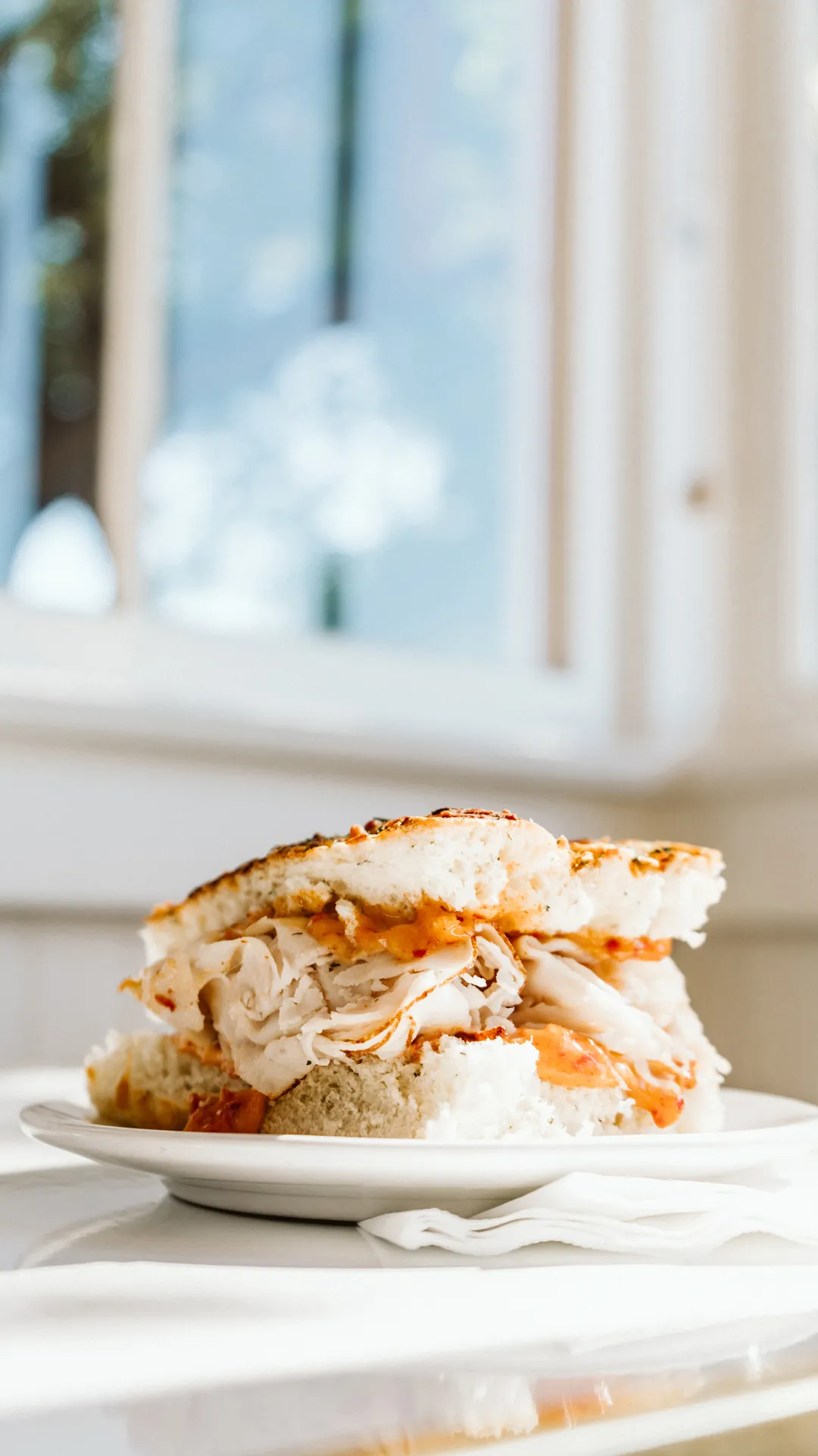 Focaccia sandwich cut in half on a white plate